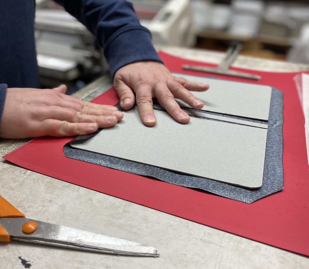 Above: Notebooks are covered by hand.